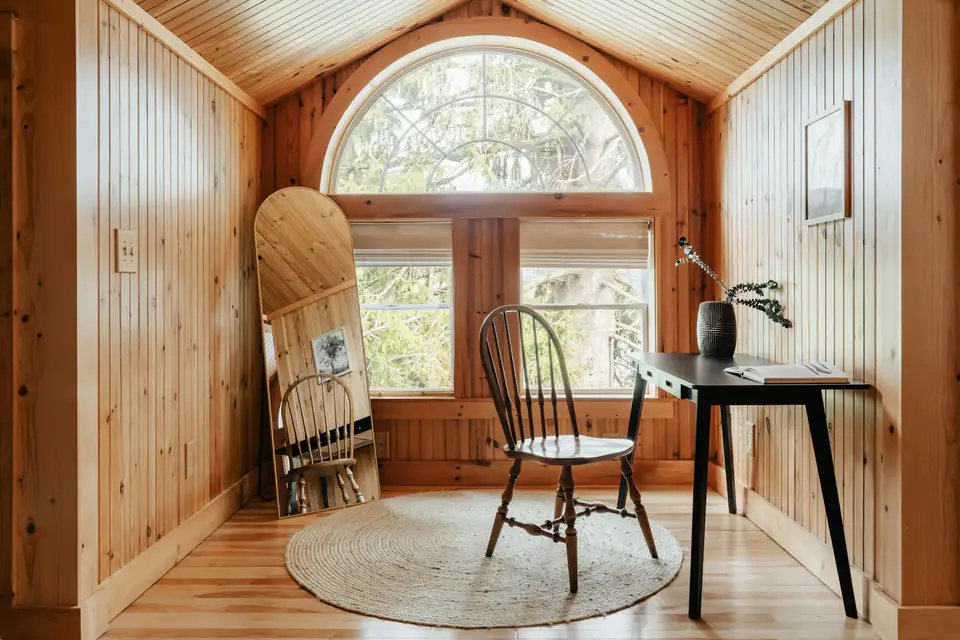 Timber-lined garden office with desk, design inspiration for garden offices in Newcastle Timber-lined garden office with a desk beneath a large window, a home working idea for Newcastle