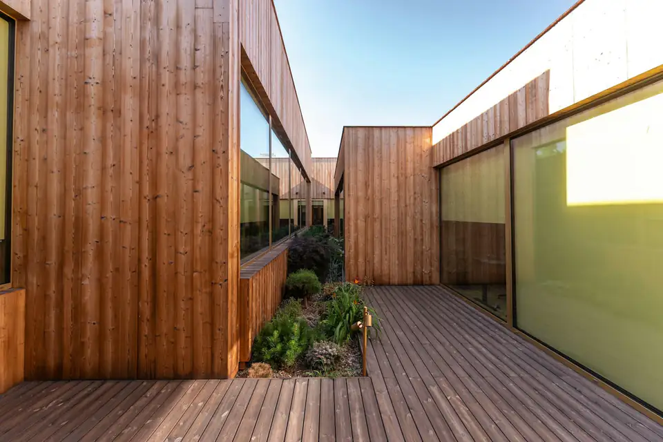 Timber-clad garden room with a deck walkway, a design idea for Durham gardens