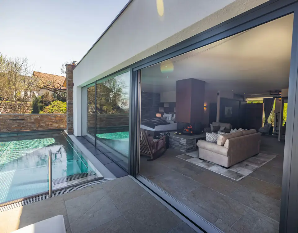 Contemporary lounge with frameless sliding glass doors, an idea for Ponteland garden rooms